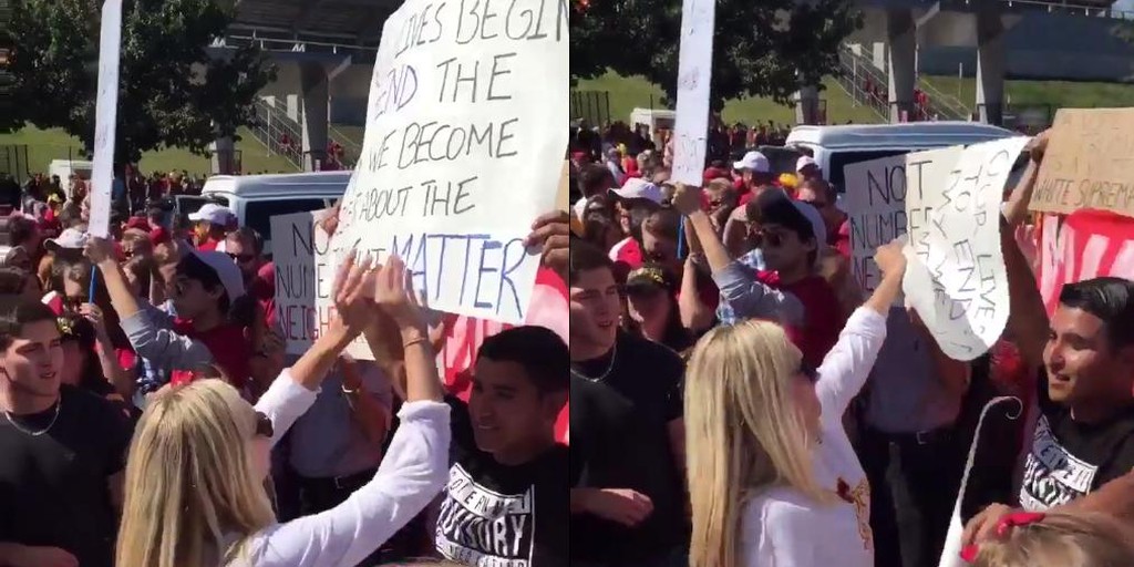 Woman rips latino man's sign at rally