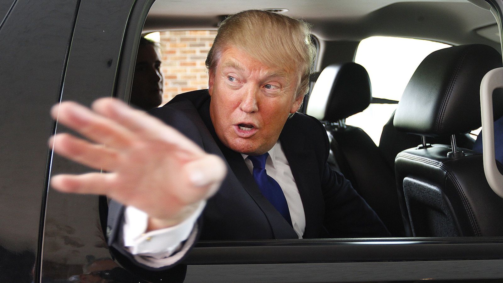 Trump waves off questions from car